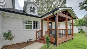 A house with a covered porch, a small garden, and a window.