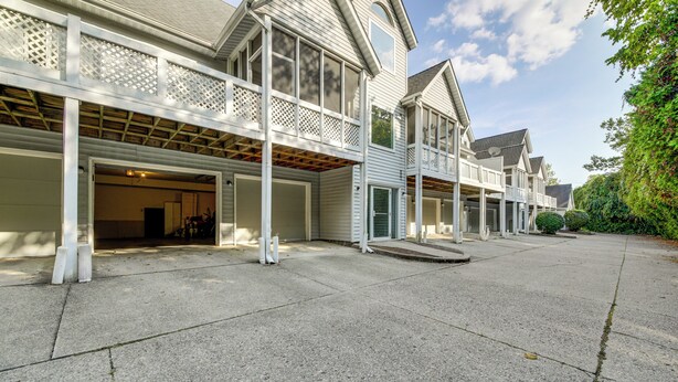 A two-story house with a covered garage and a balcony. - 3 Mi to IU: Dog-friendly Condo w/ Pool Access! (Bloomington)