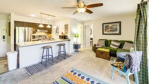 A compact living space with a kitchenette, a dining area, and a seating area with a sofa and a chair. - 3 Mi to IU: Dog-friendly Condo w/ Pool Access! (Bloomington)