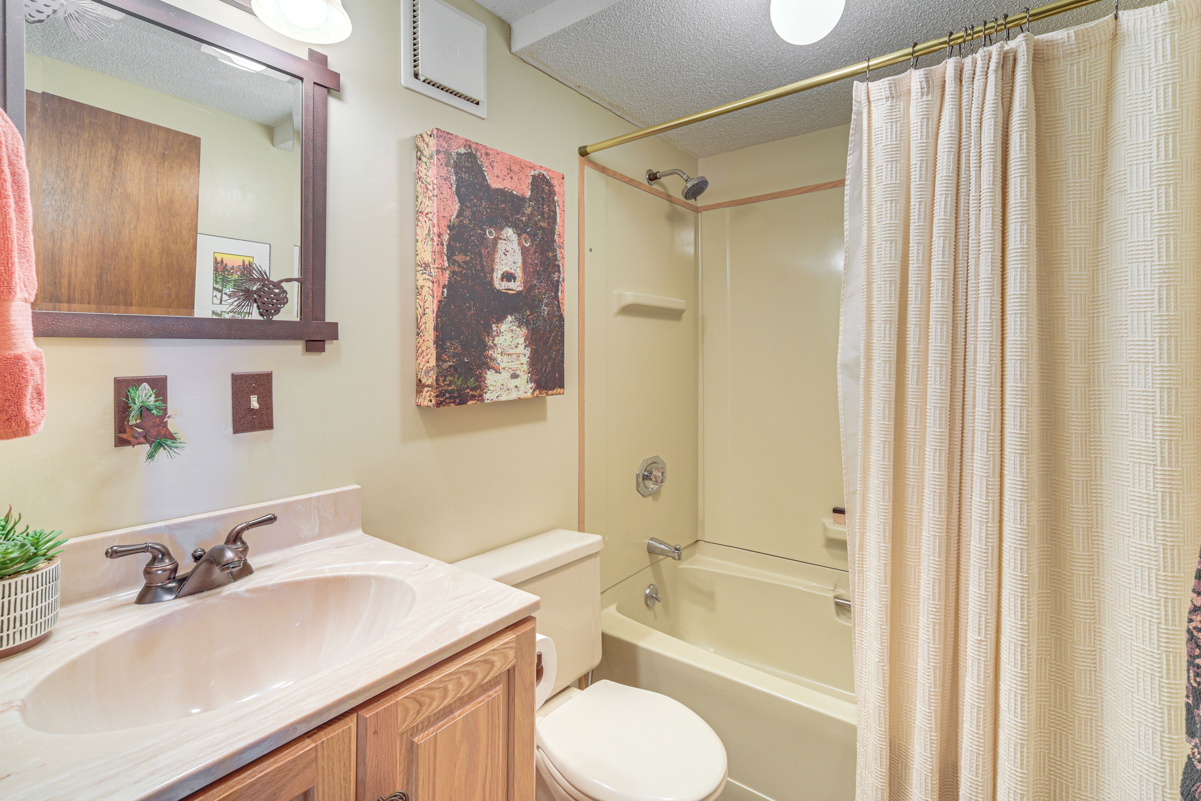 A bathroom with a sink, toilet, and bathtub.
