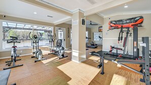 A gym with various exercise equipment, large windows, and a ceiling fan. - Waterfront Living & Resort Perks! Lake Norman Stay (Sherrills Ford)