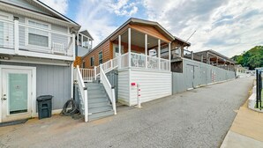 A residential building with a porch, a staircase, and a garage door. - Waterfront Living & Resort Perks! Lake Norman Stay (Sherrills Ford)