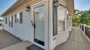 A house with a covered porch, a front door with a glass panel, and a small step leading to the entrance. - Breathtaking Lake Views and Sunsets on Badin Lake! (New London)