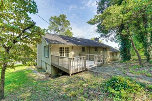 A two-story house with a porch, surrounded by trees and a grassy yard. - Clinton Retreat Near Norris Lake & Knoxville (Clinton)