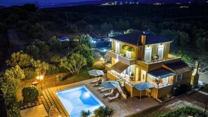 A two-story house with a swimming pool, outdoor seating, and a view of the surrounding landscape. - Ktima KiKa - Private Pool Escape & Tranquility (Memi)