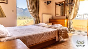 A bedroom with a large bed, a bedside table, a radiator, and a balcony with curtains. - Ktima KiKa - Private Pool Escape & Tranquility (Memi)