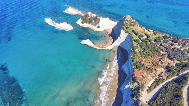 An aerial view of a coastal area with clear blue waters, sandy beaches, and rocky terrain. - Villa Amarilda - Private Pool Garden in Corfu (Corfu)