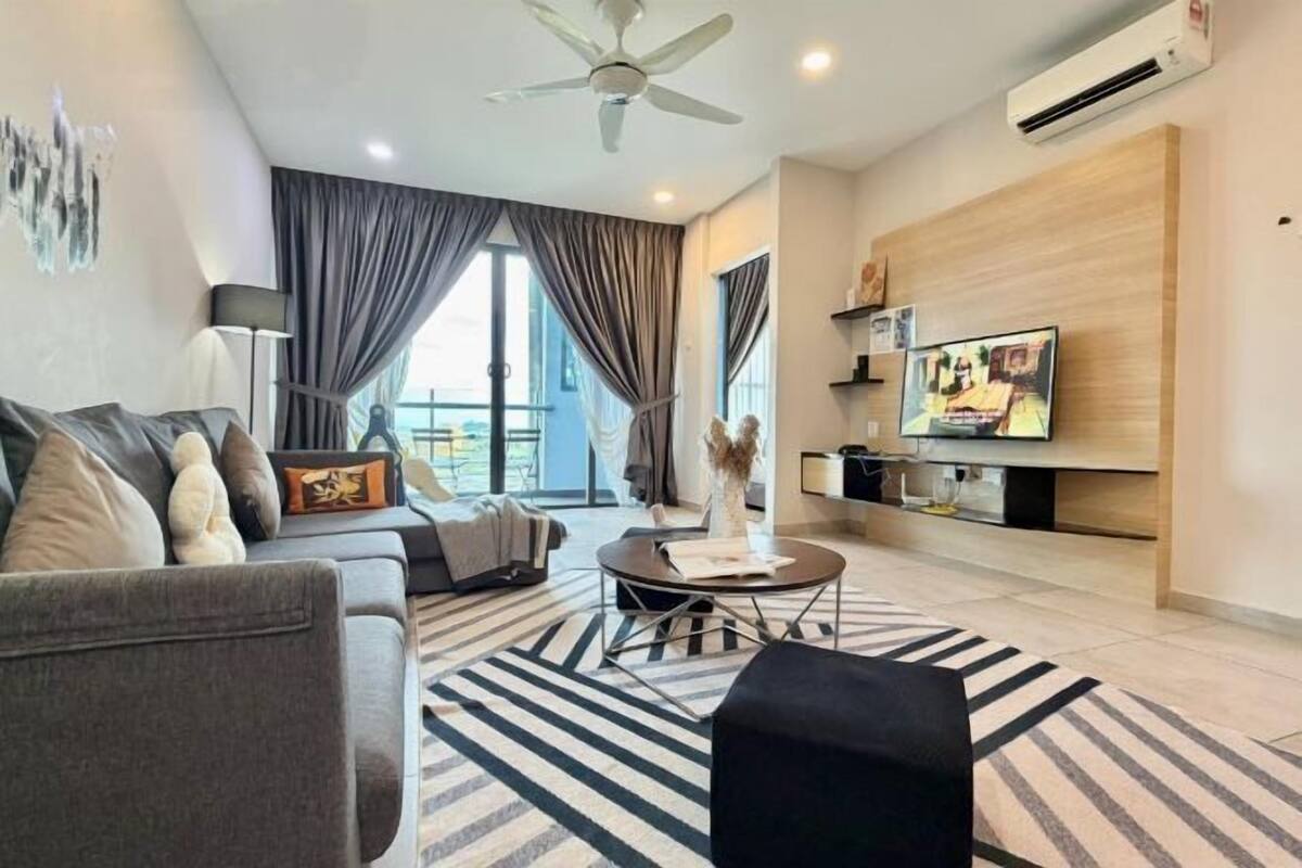 A modern living room with a sofa, coffee table, and TV.