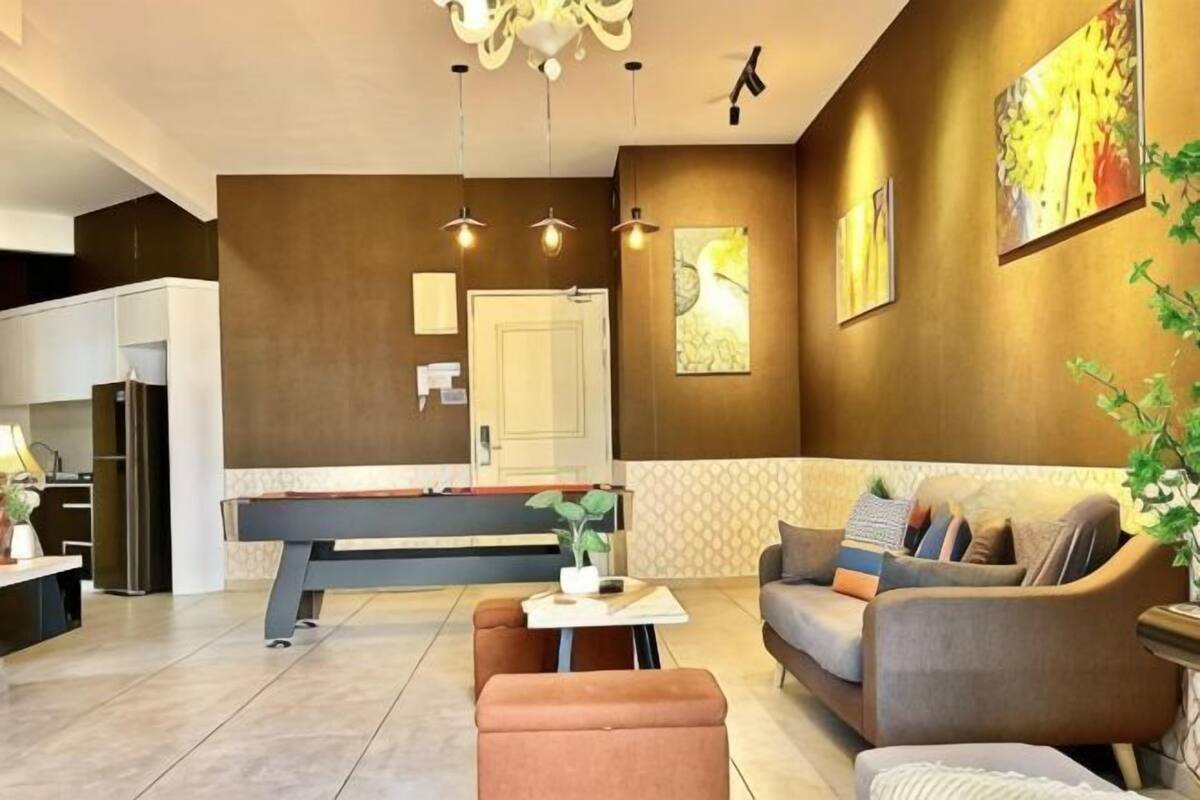 A modern living room with a sofa, coffee table, and a dining area with a bench.