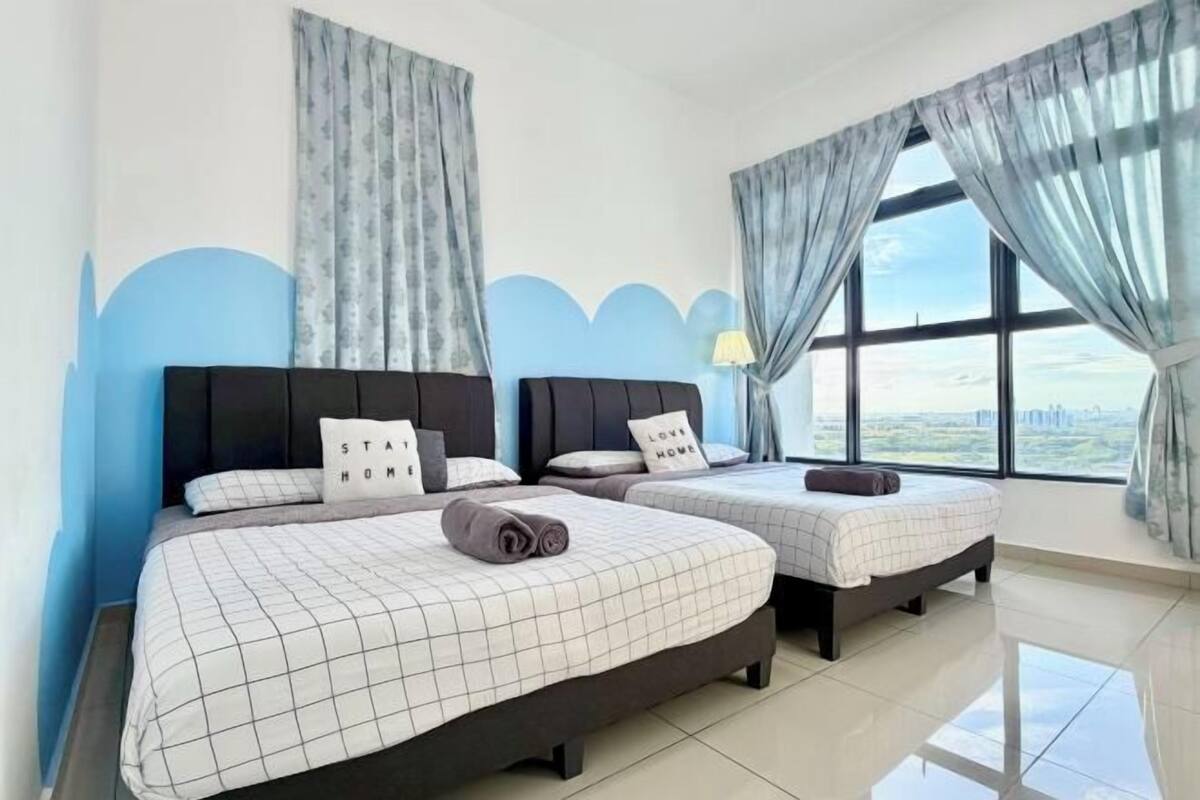 A hotel room with two beds, a view of the city, and a modern design.