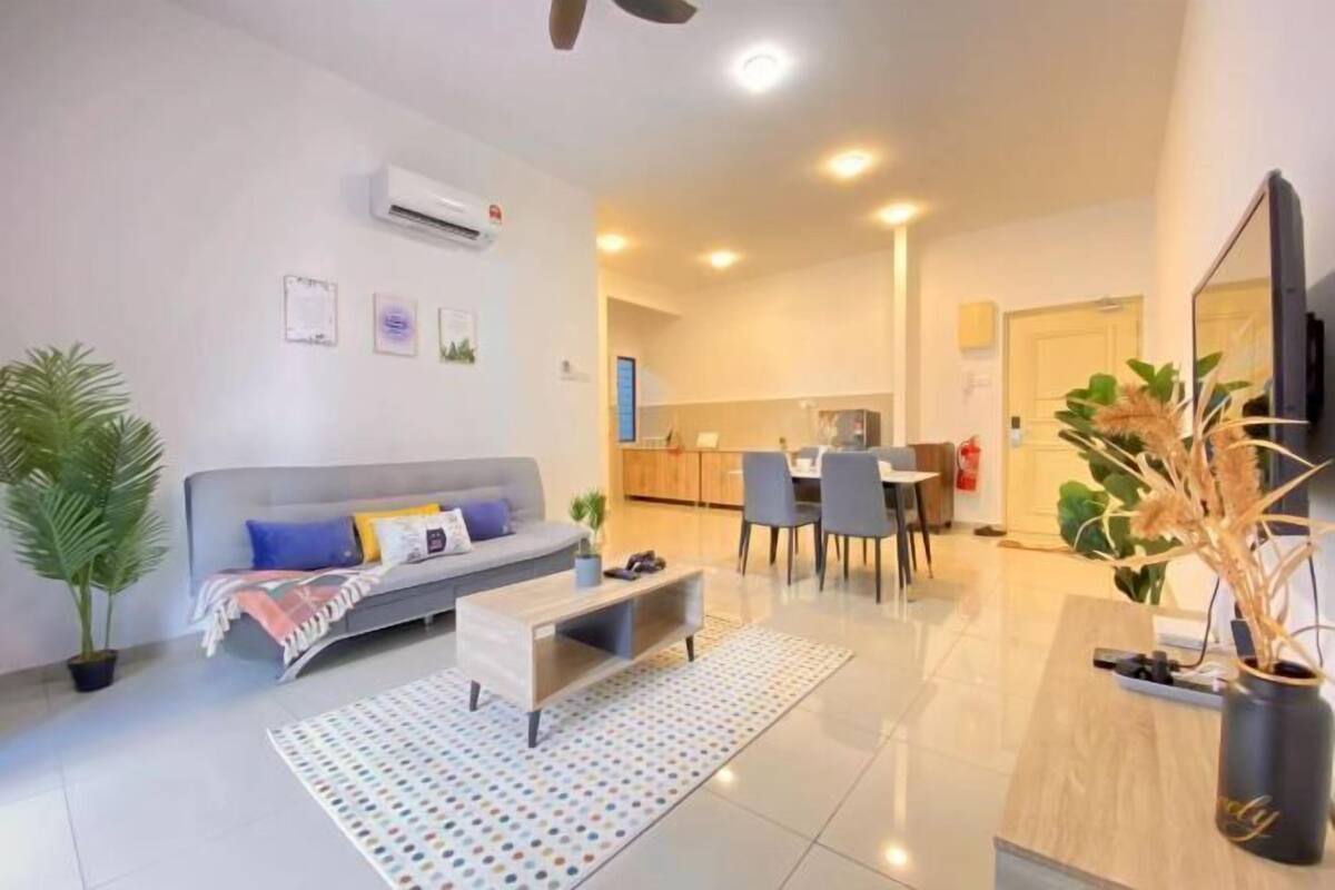 A modern living room with a sofa, coffee table, and dining area.