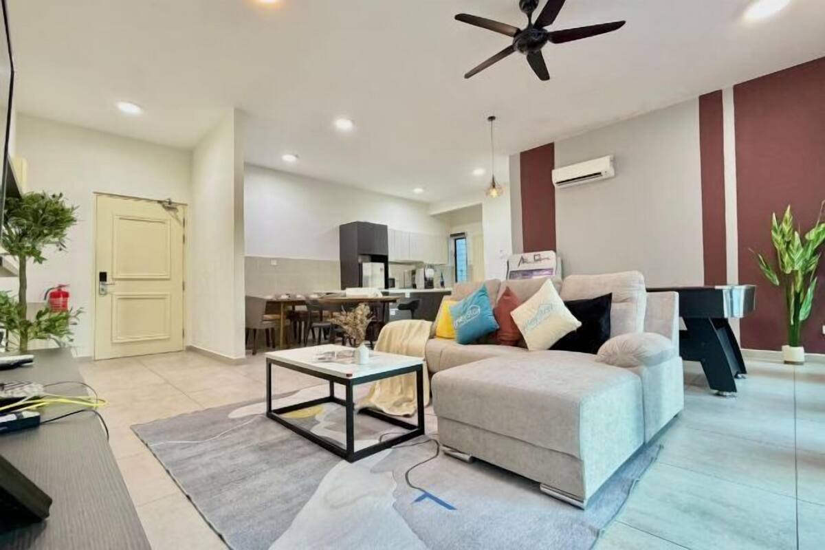 A modern living room with a sofa, coffee table, and ceiling fan.