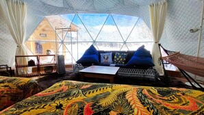 A tented accommodation with a sofa, cushions, a table, and a hammock. - Glamping+Sauna Hakuba morino wasabi nouen (Kitaazumi District)