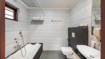 A modern bathroom with a bathtub, toilet, and sink.