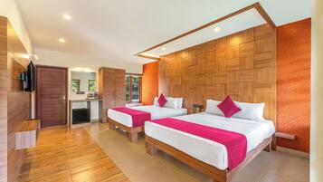 A modern hotel room with two beds, wooden headboards, a flat-screen TV, and a small desk area.