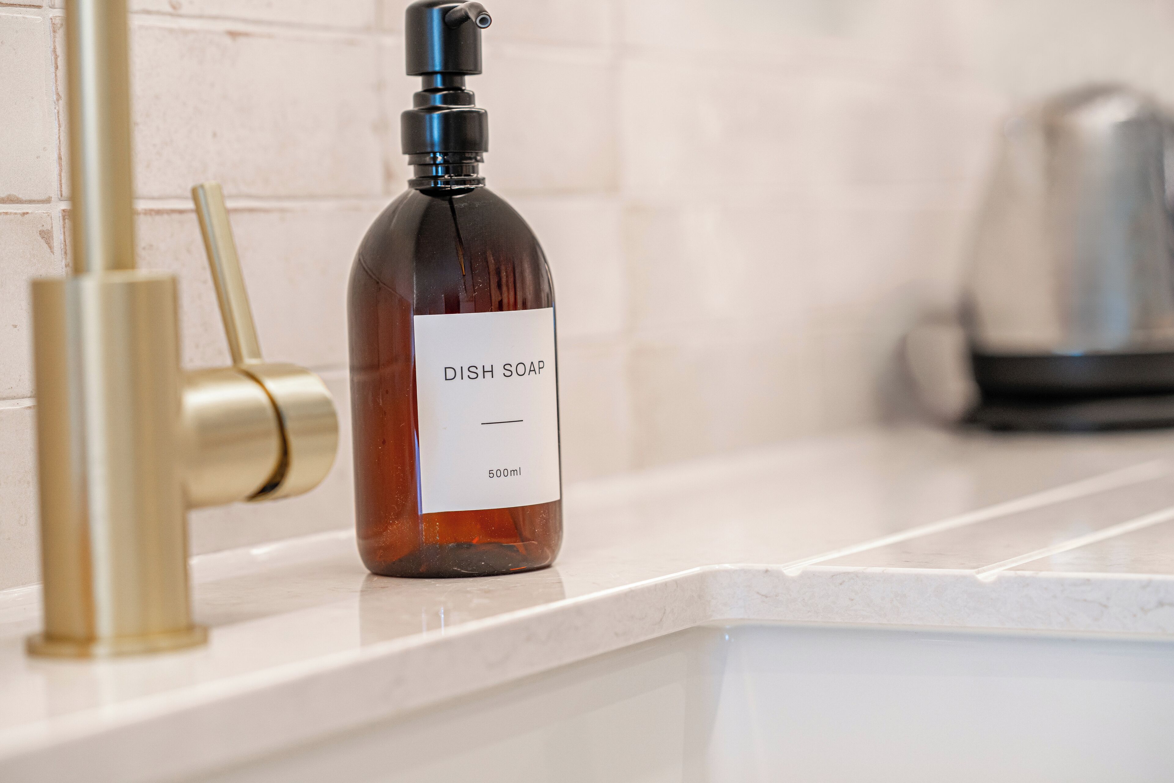A bottle of dish soap on a kitchen counter.