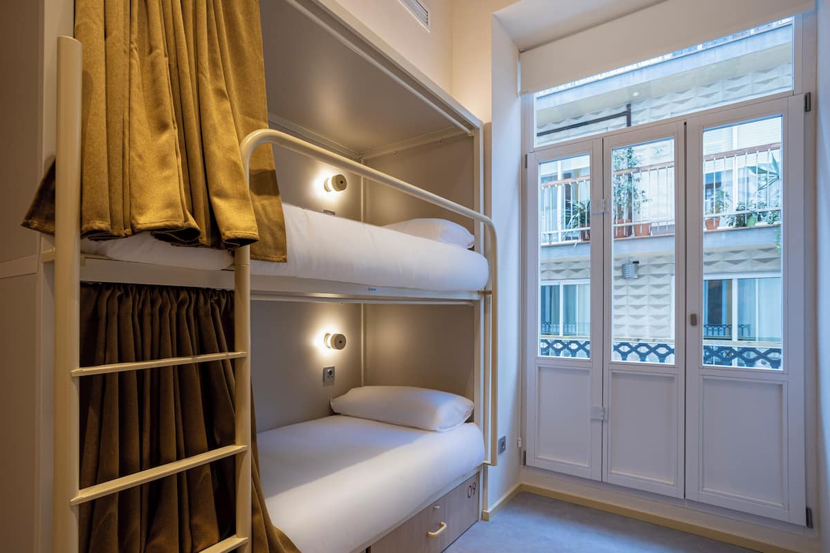Bed in mixed 4-bed dormitory with adapted private bathroom | Premium bedding, blackout drapes, soundproofing, iron/ironing board