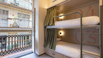 A bunk bed room with a window, a balcony, and a number '04' on the wall.