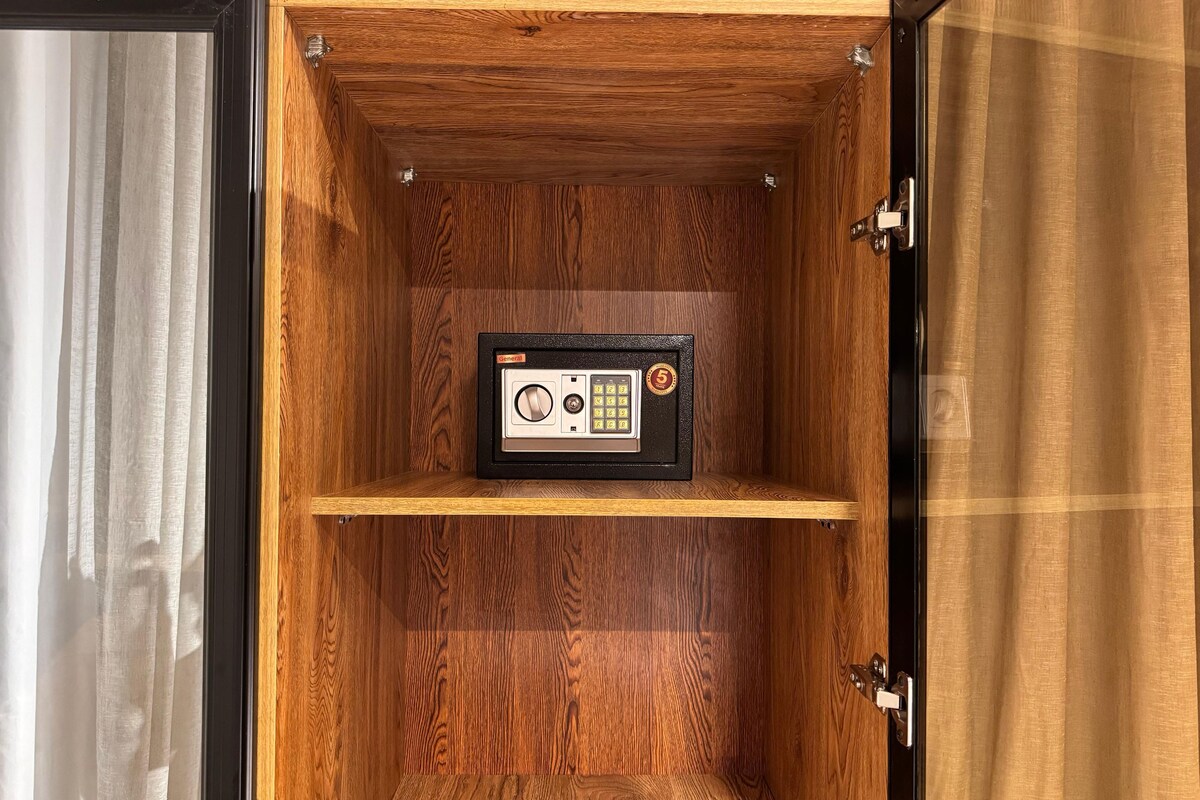 A wooden cabinet with a safe inside.