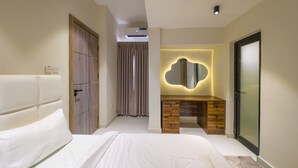 A modern bedroom with a large bed, a wooden dresser, a mirror, and a sliding door. - Glassvine - 1D (Lagos)