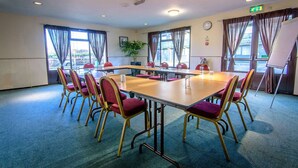 A conference room with a large table, red chairs, and a whiteboard. - The Runmere Hotel, Liverpool South (Runcorn), Part of the AG Collection (Runcorn)