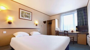 A hotel room with a large bed, a desk with a chair, a television, and a window with curtains. - The Runmere Hotel, Liverpool South (Runcorn), Part of the AG Collection (Runcorn)