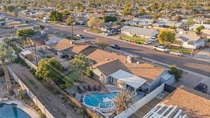 A residential area with houses, a swimming pool, and a mountain in the background. - Heated Pool | Putting Green | 7 Min Old Town (Scottsdale)