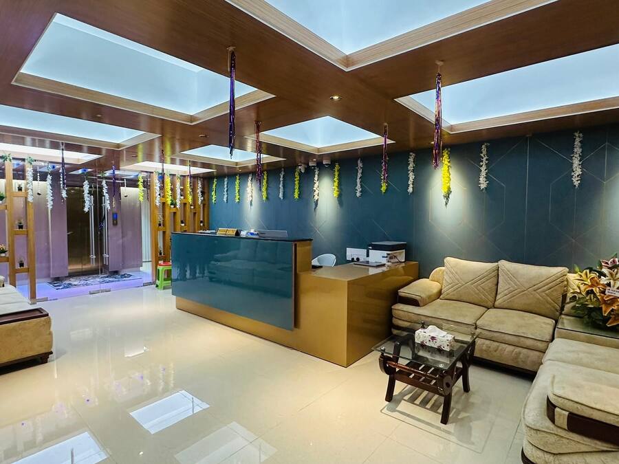 A modern reception area with a reception desk, sofas, and a glass coffee table.