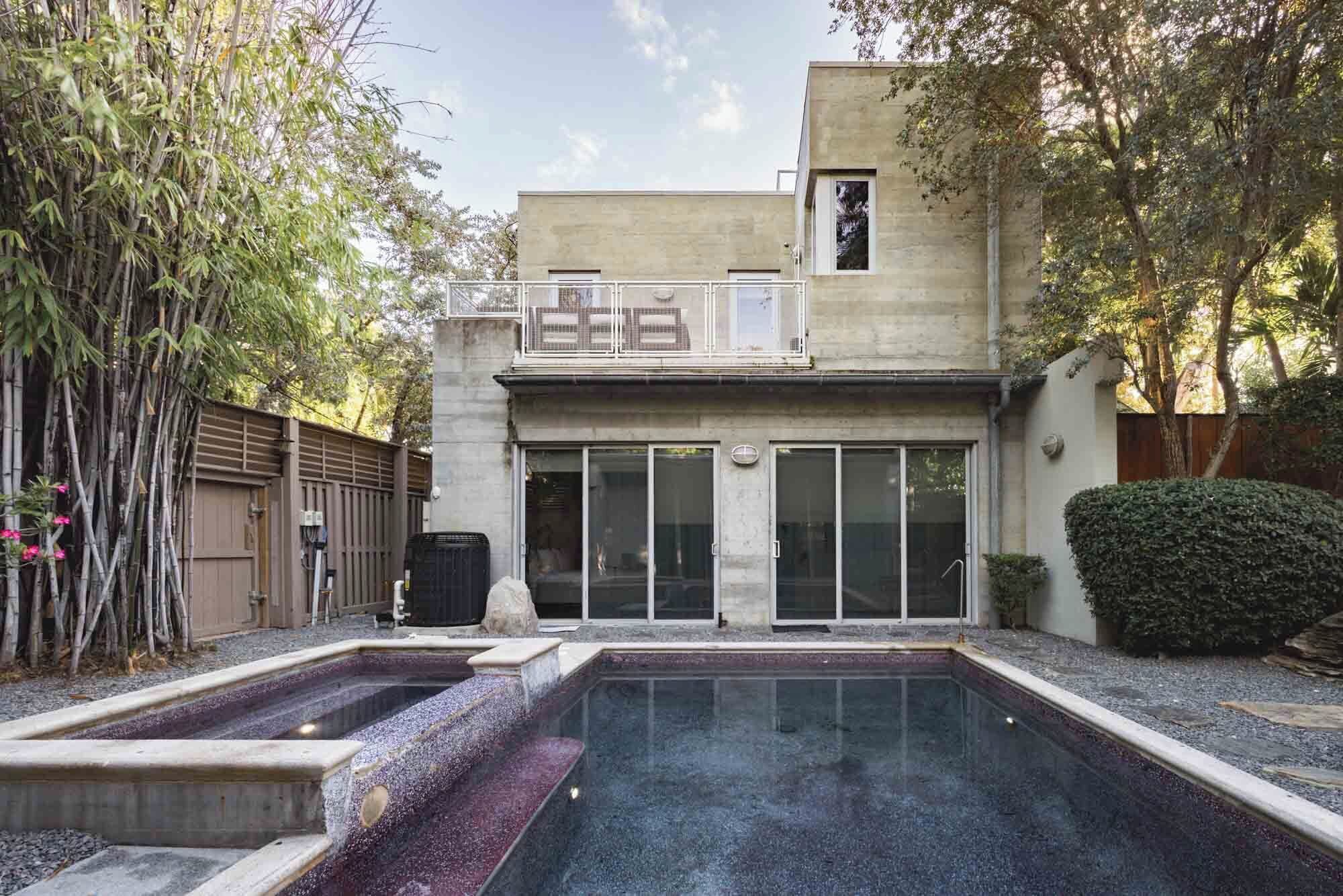 A modern building with a pool, large glass doors, and a sign that reads "BREEZE."