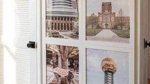 A wall with framed pictures of various buildings and landmarks.