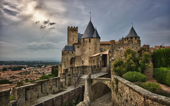 A historic stone castle with multiple towers and a fortified entrance.