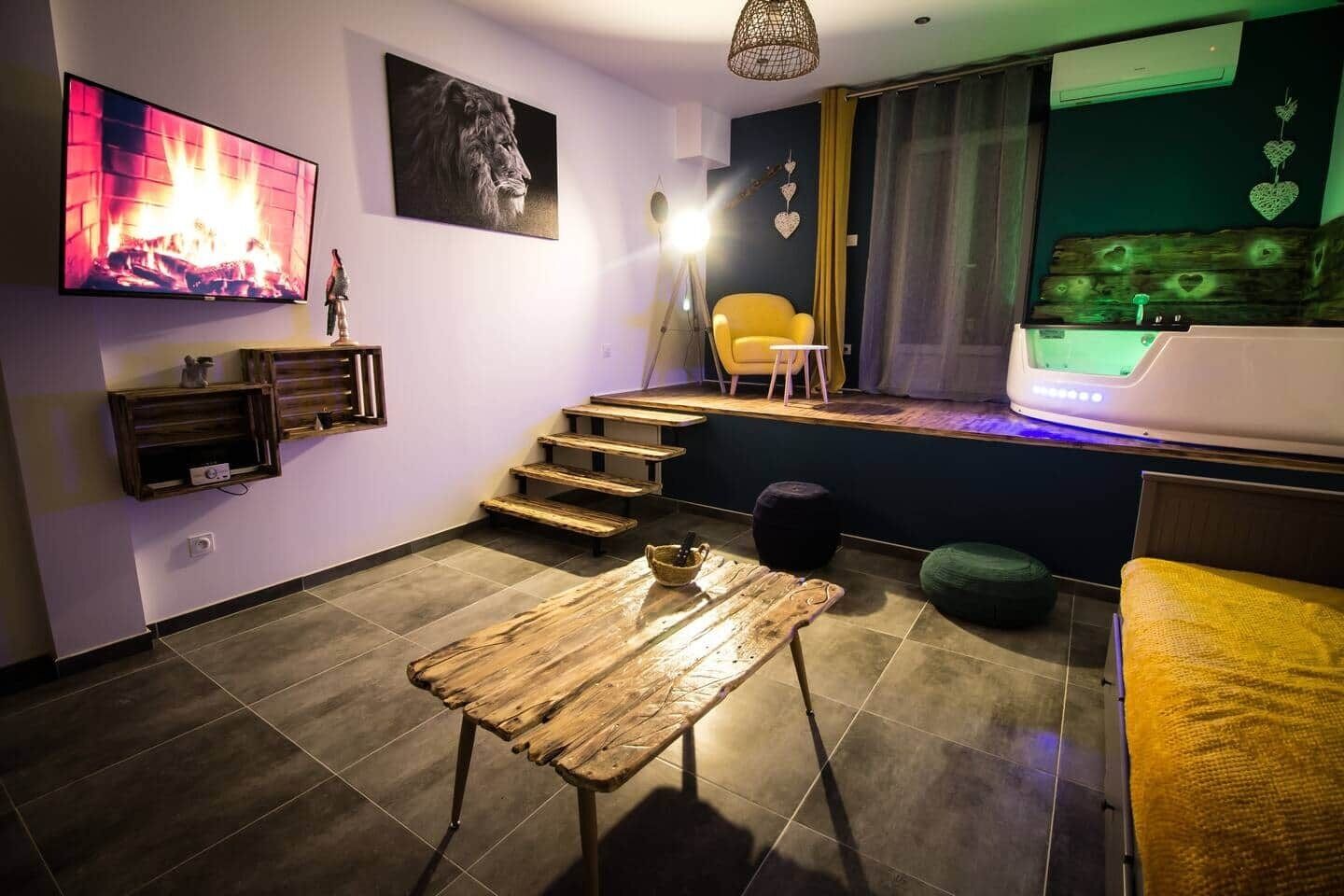 Een moderne woonkamer met een open haard, een trap, een gele fauteuil en een flatscreen-televisie.