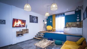 A modern living space with a staircase, a sofa, a table, and a bathtub. - T2 with jacuzzi and terrace (Carcassonne)
