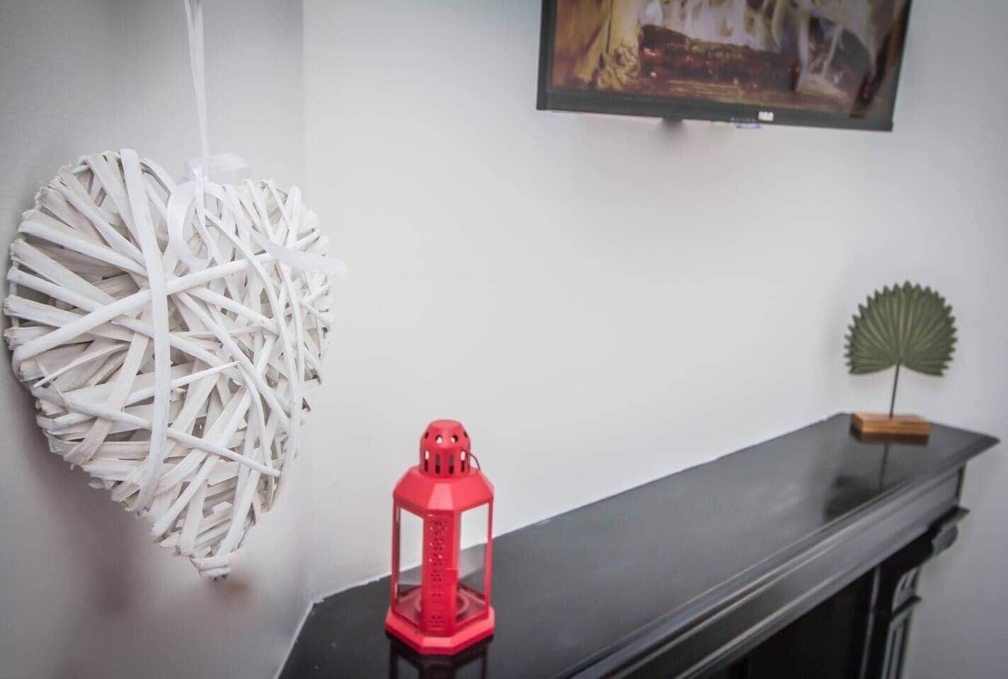 A room with a black table, a red lantern, and decorative items on the wall.