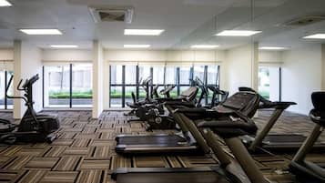 A gym with treadmills, elliptical machines, and stationary bikes.