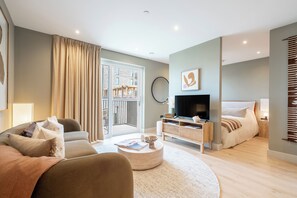 Basic Studio, Balcony, City View | Living area | 32-inch TV with digital channels