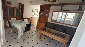 A living room with a dining table, chairs, a sofa, and a TV. - Holiday Home 'Centrico Piso En Marbella' with Private Terrace and Wi-Fi (Marbella)