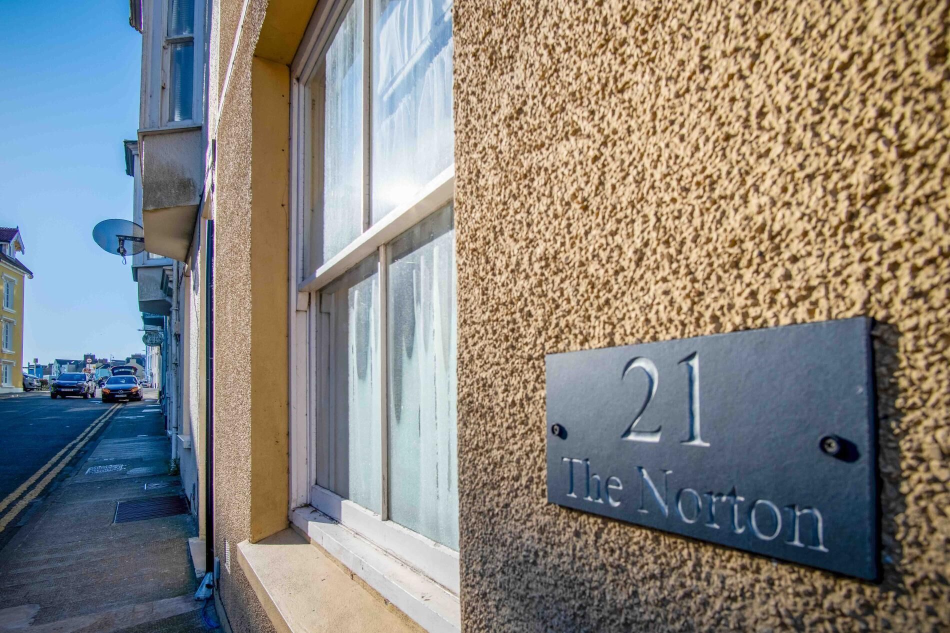 A building with a sign reading "21 The Norton" indicating the address.