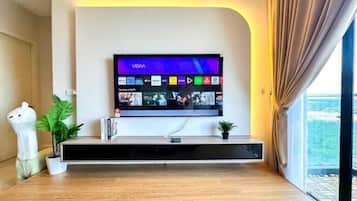 A modern living room with a mounted flat-screen TV displaying a VIVA app interface.