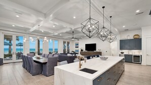 A modern kitchen with a large island, built-in appliances, and a view of the ocean. - Seaside Serenity|Gulf Front|Private Beach Access|Private Pool (Seagrove Beach)