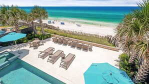 A pool area with lounge chairs and umbrellas, overlooking a beach with clear blue water. - Seaside Serenity|Gulf Front|Private Beach Access|Private Pool (Seagrove Beach)