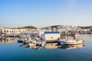 A harbor with boats docked, a small white building, and white buildings in the background. - Gabbie - Four Bedroom Villa, Sleeps 8 (Santa Maria)