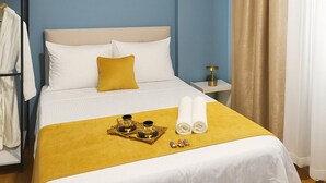 A hotel room with a bed, a bedside table, a nightstand, a wardrobe, and a window with curtains. - Casafra (Istanbul)