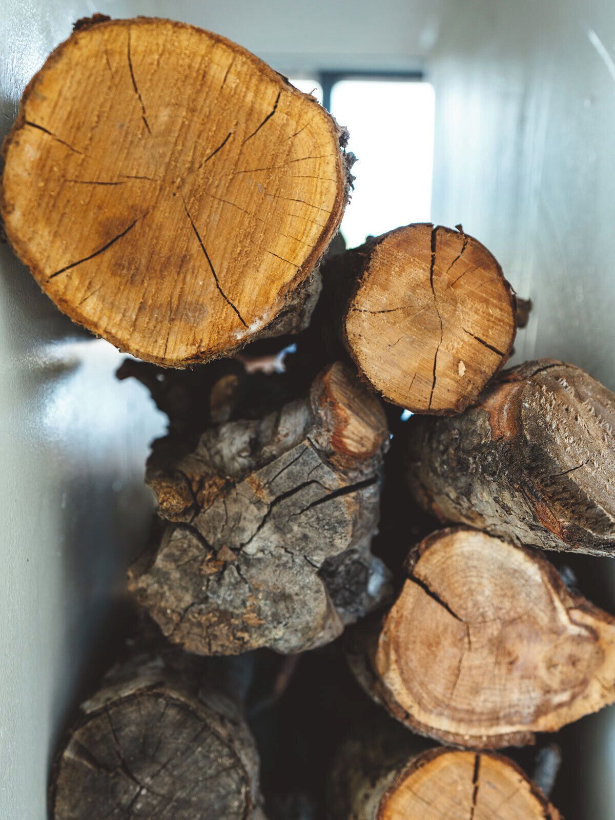 A close-up of stacked logs with visible tree rings and bark textures.