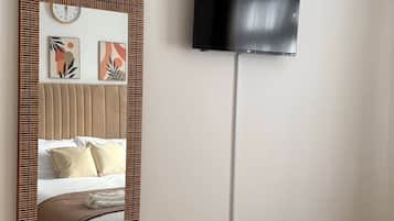 Hypo-allergenic bedding, desk, laptop workspace, blackout drapes