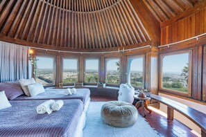 A spacious room with two beds, large windows, and a wooden ceiling. - Bem Parece by Umbral (Albufeira)