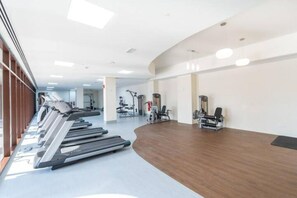 A gym with treadmills, exercise bikes, and weight machines. - Jumeirah Golf Estates Sleeps 2 With Balcony Views (Dubai)