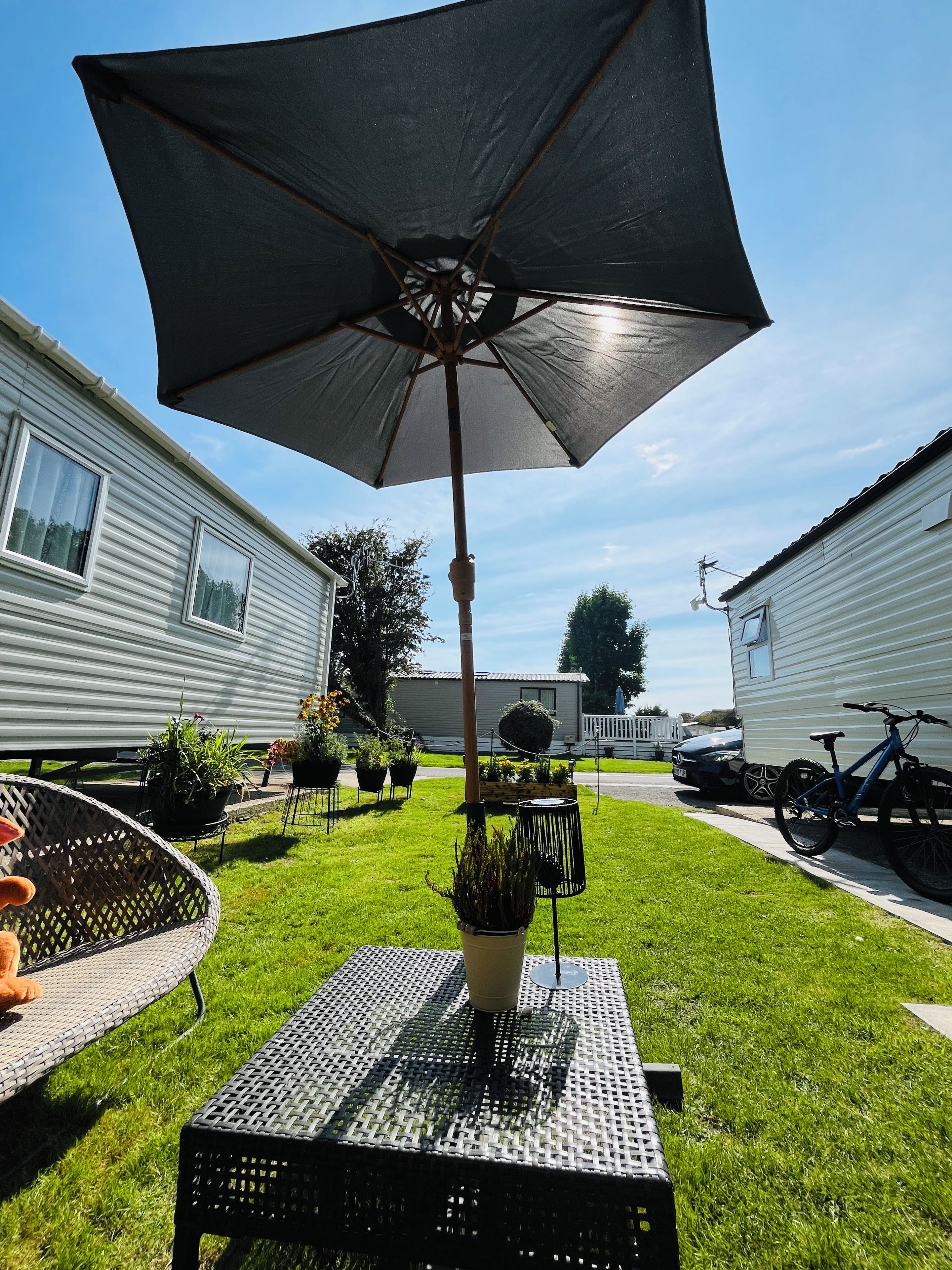 A patio area with a table, chairs, and an umbrella.