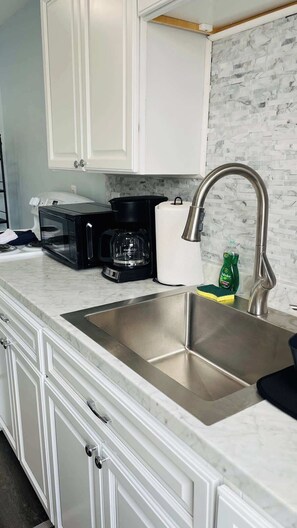 Fridge, stovetop, coffee/tea maker, cookware/dishes/utensils
