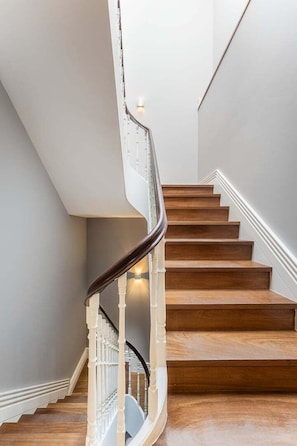 A staircase with wooden steps and white railings.